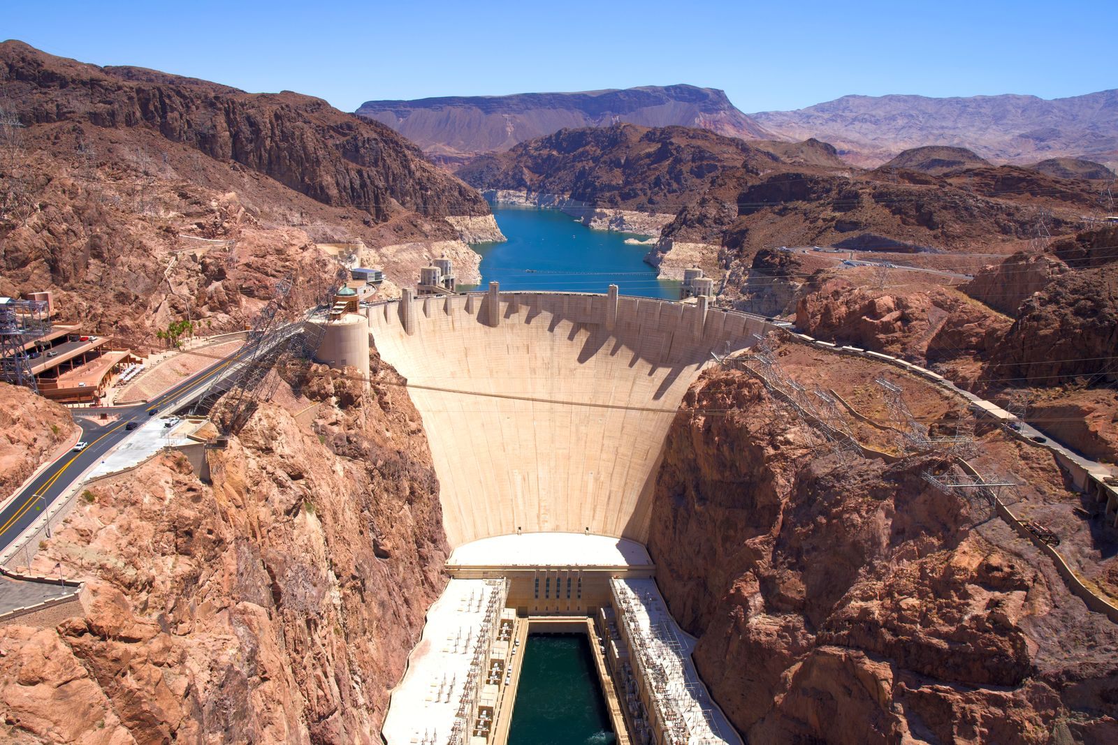Hoover Dam curving between red rock canyon walls with Lake Mead behind, a classic Las Vegas day trip