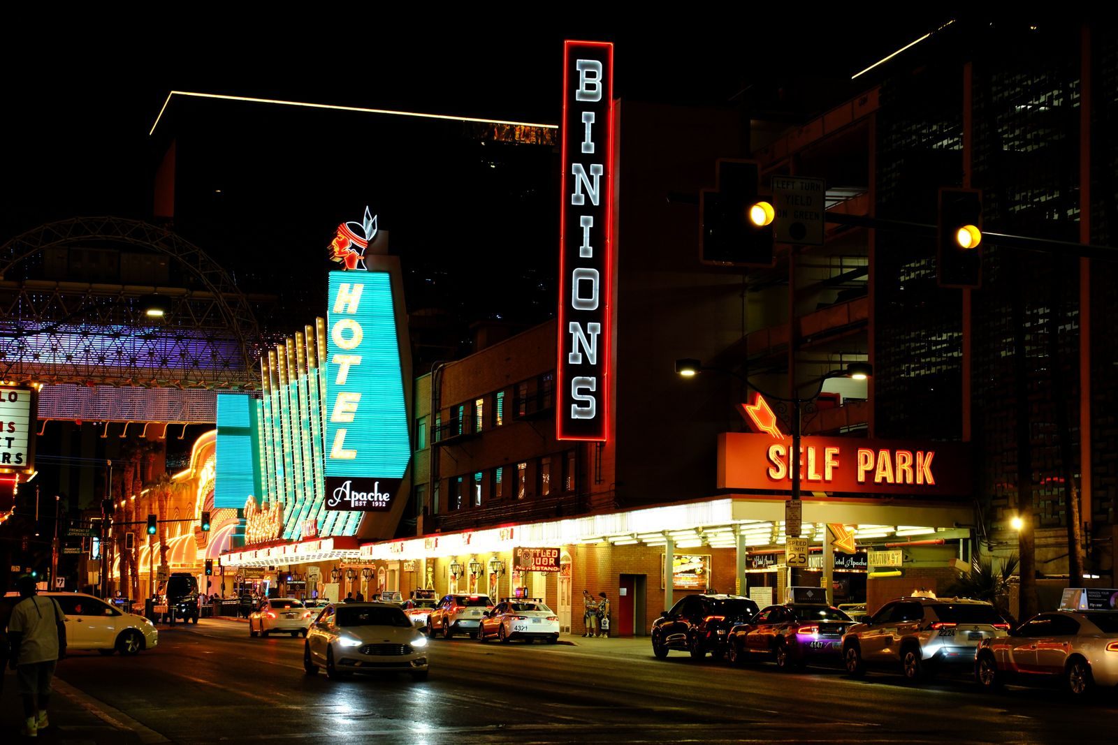 Binion's neon signs glowing over a downtown street near the Fremont Street Experience at night