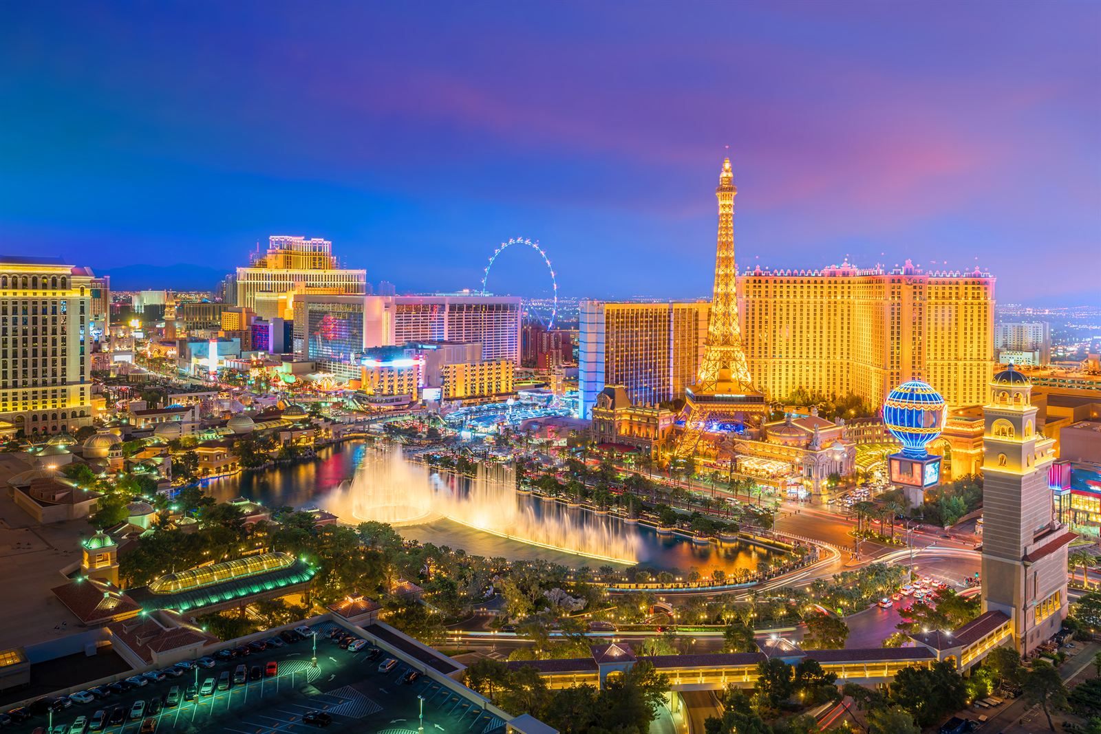 The Las Vegas Strip at dusk, with the Bellagio fountains, the Paris Eiffel Tower and the High Roller lit up, where many things to do in Las Vegas are found